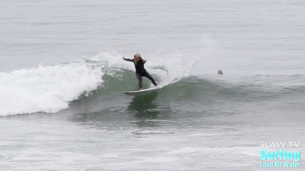 girl groms surfing waves at lowers trestles