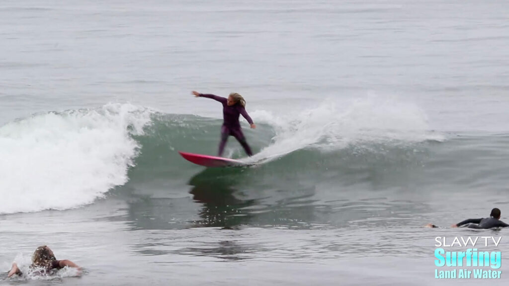 girl groms surfing waves at lowers trestles