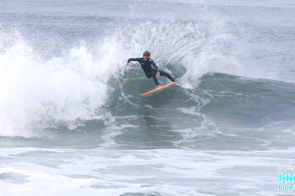 groms and young surfers riding waves in cardiff by the sea