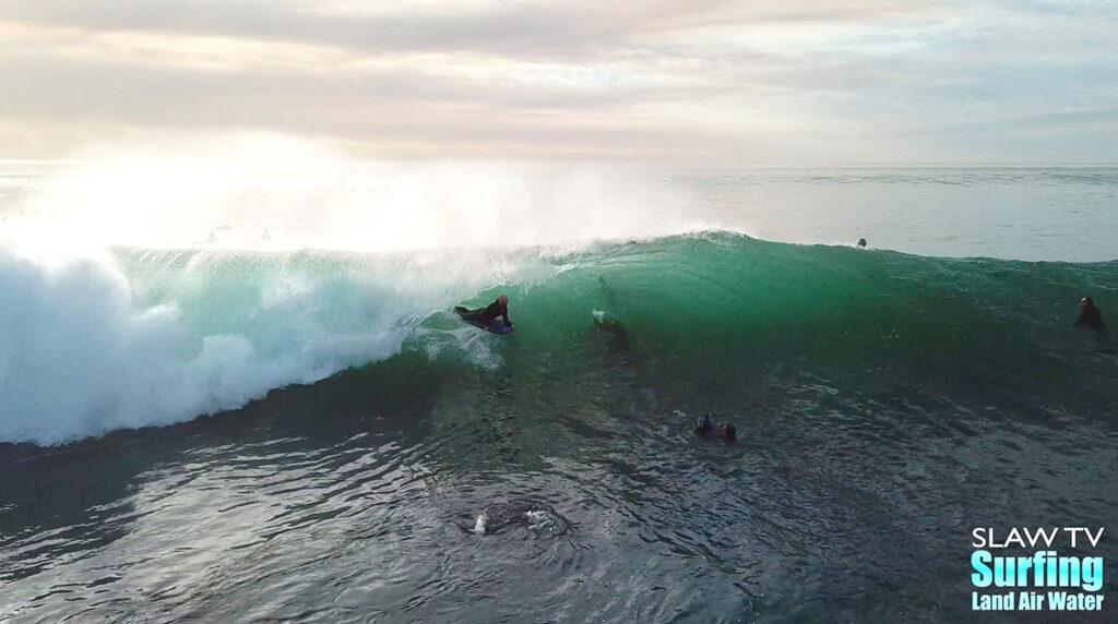 surfing aerial photo of barreling waves in san diego