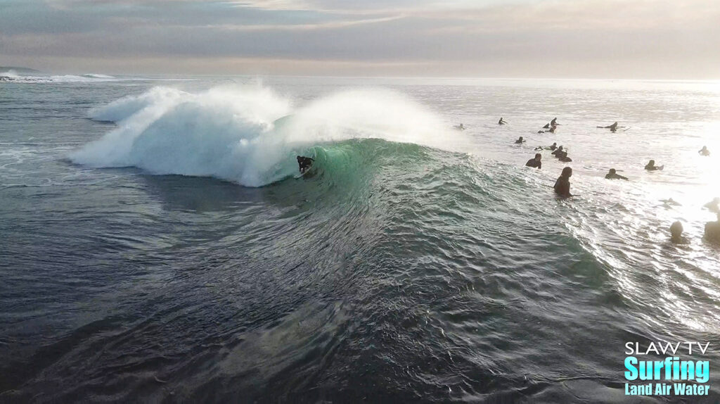 surfing aerial photo of barreling waves in san diego