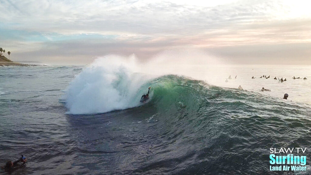 surfing aerial photo of barreling waves in san diego