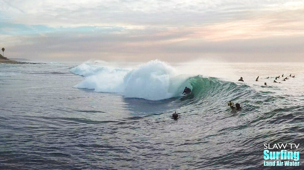 surfing aerial photo of barreling waves in san diego