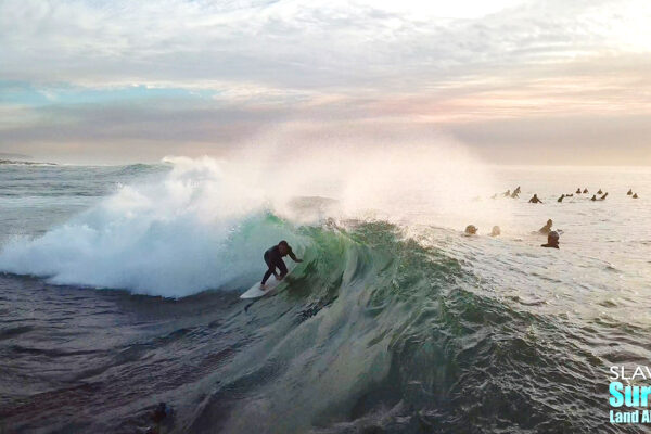 surfing aerial photo of barreling waves in san diego