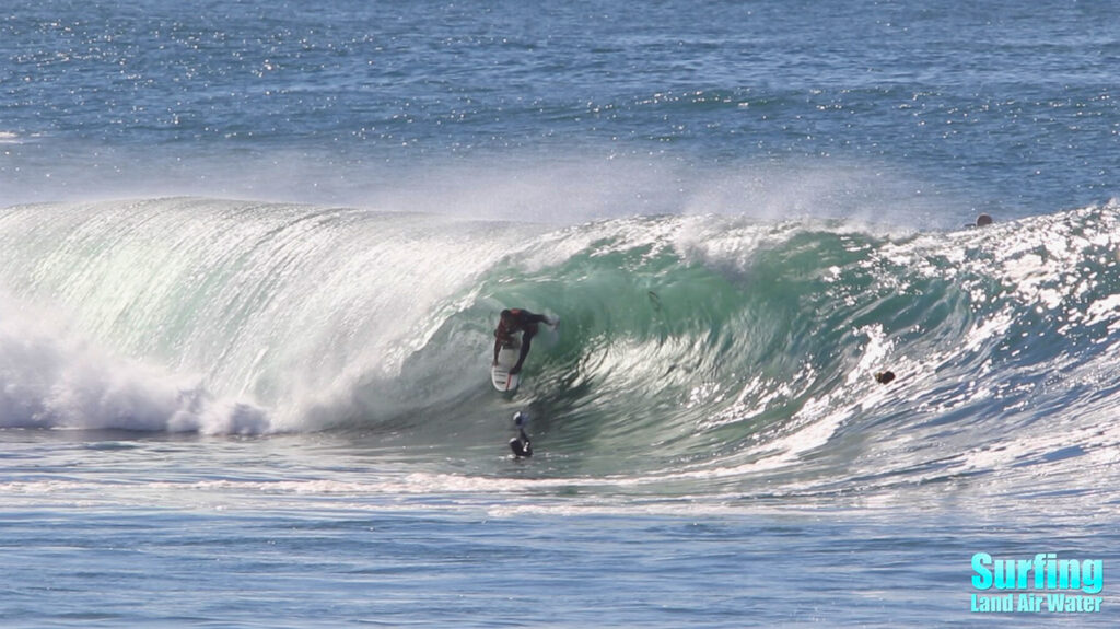 surfing big barreling waves at la jolla reef in san diego