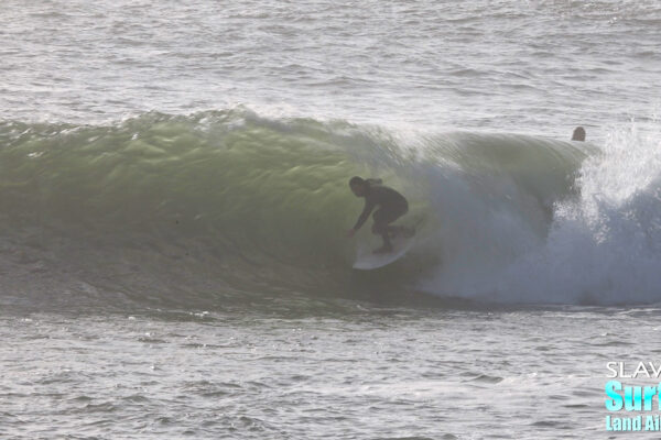 surfing a novelty sandbar on the california coastline with barreling waves