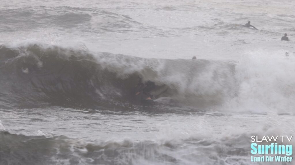 surfing a california sandbar wave that has hollow barrels