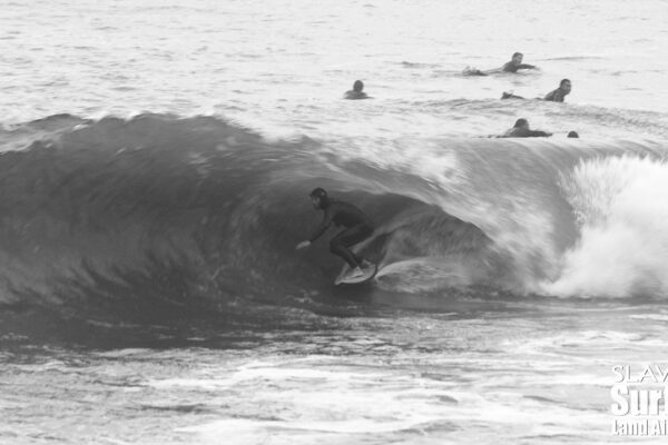 surfing a california sandbar wave that has hollow barrels