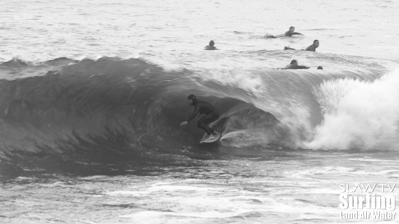 surfing a california sandbar wave that has hollow barrels