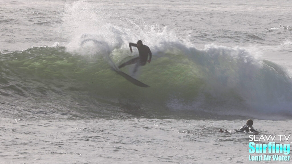 surfing a california sandbar wave that has hollow barrels