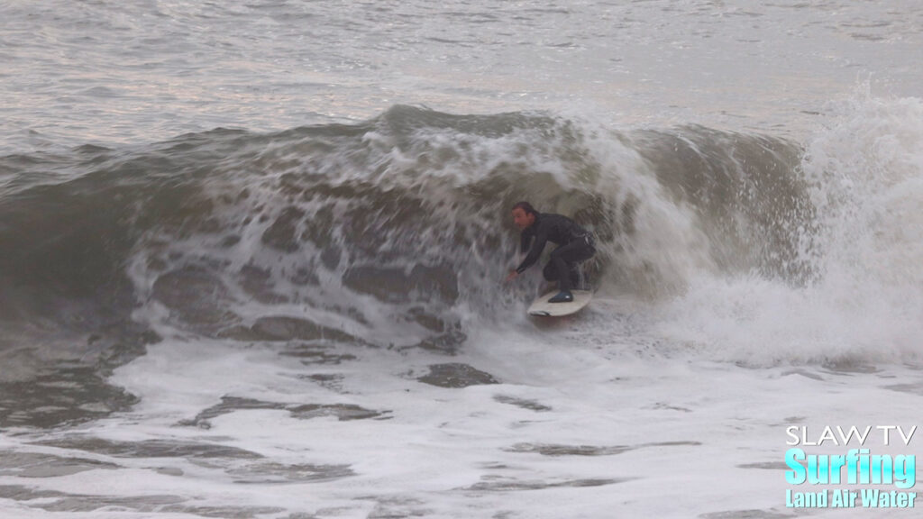 zeke surfing a california sandbar wave that has hollow barrels